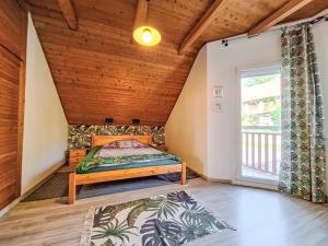 a bedroom with a bed in a room with a window at Apartment Bonika by Interhome in Fonyód