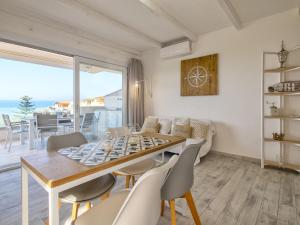 a dining room and living room with a table and chairs at Apartment Mare Azzurro by Interhome in La Ciaccia