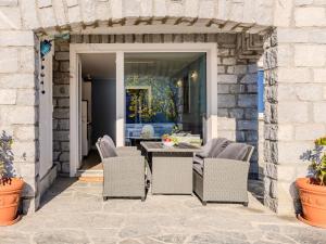 an outdoor patio with a table and chairs at Apartment Lago Infinito by Interhome in Gravedona