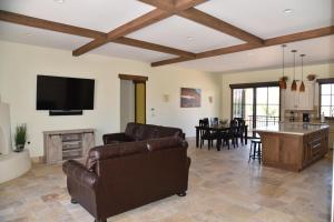 a living room with a couch and a tv and a table at New Lodge In The Heart Of Moab, Utah in Moab
