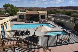 a view of a swimming pool from a balcony at New Lodge In The Heart Of Moab, Utah in Moab +20 photos