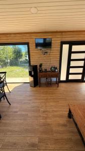 a living room with a flat screen tv on the wall at Cabaña independiente Quillón in Chillancito