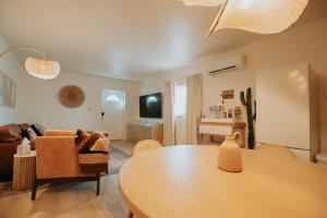 a living room with a table and a couch at Terracotta Suite at ArnoTriplex! Hot Tub and Pet Friendly! in Albuquerque