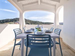 a table and chairs on a balcony with a view at Holiday Home La Conchiglia D'oro by Interhome in Budoni