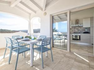 a kitchen and dining room with a table and chairs at Holiday Home La Conchiglia D'oro by Interhome in Budoni +53 photos