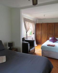 a bedroom with a bed and a chair and a window at Misty View Farm Stay in Towerhill +27 photos