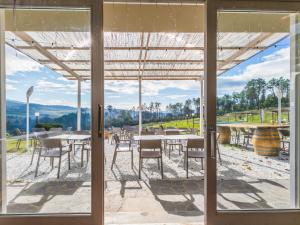 a view from the glass door of a patio with tables and chairs at Holiday Home Casa di Palaia by Interhome in Greve in Chianti