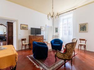 a living room with chairs and a table and a tv at Apartment Casa del Capitano by Interhome in San Bartolomeo al Mare +21 photos