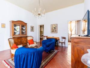 a living room with blue chairs and a table at Apartment Casa del Capitano by Interhome in San Bartolomeo al Mare