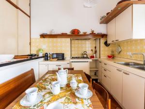 a kitchen with a wooden table with cups on it at Apartment Casa del Capitano by Interhome in San Bartolomeo al Mare