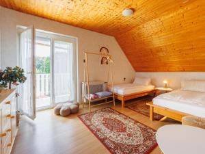 a living room with a bed and a large window at Apartment Noisette by Interhome in Balatonkeresztúr