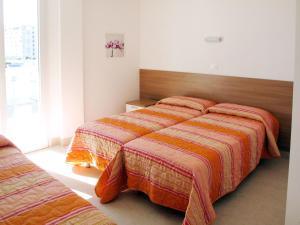 En eller flere senge i et værelse på Apartment Fiore-9 by Interhome