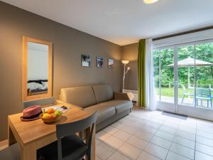 a living room with a couch and a table at Holiday Home Cottage Privilège-1 by Interhome in Saumur