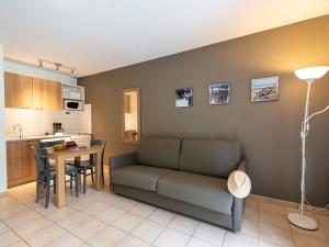 a living room with a couch and a table at Holiday Home Cottage Privilège-1 by Interhome in Saumur +29 photos