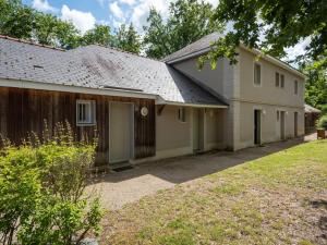 a house with a garage and a fence at Holiday Home Cottage Privilège-1 by Interhome in Saumur
