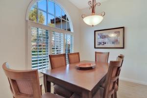 a dining room with a table and chairs and a window at Secluded Ground Floor 1BR Villa #A in La Quinta