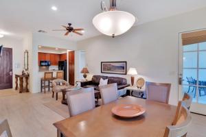 a dining room and living room with a table and chairs at Secluded Ground Floor 1BR Villa #A in La Quinta