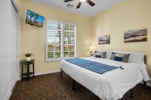 a bedroom with a large bed and a window at Picturesque 1BR in Legacy Villas near Main Pool #A in La Quinta +21 photos