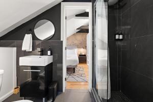a bathroom with a white sink and a mirror at The Ontario Loft Suites in Montréal +78 photos