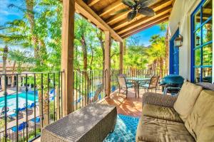 a screened in porch with a couch and a table at Legacy Villas Hideaway overlooking Main Pool #A in La Quinta
