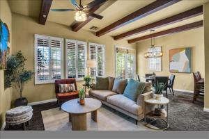 a living room with a couch and a table at Legacy Villas Hideaway overlooking Main Pool #A in La Quinta