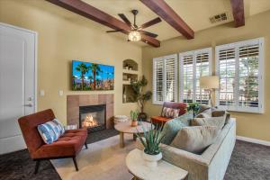 a living room with a couch and a fireplace at Legacy Villas Hideaway overlooking Main Pool #A in La Quinta