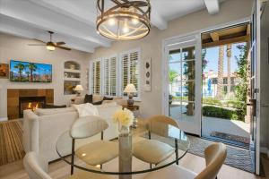 a living room with a couch and a table at Modern LQ 3BR Getaway Steps to pool & spa in La Quinta