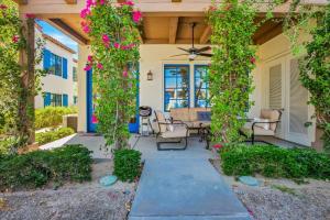 a home with a covered patio with pink flowers at Modern LQ 3BR Getaway Steps to pool & spa in La Quinta
