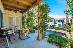 a patio with a table and chairs and a ceiling at Modern LQ 3BR Getaway Steps to pool & spa in La Quinta +35 photos