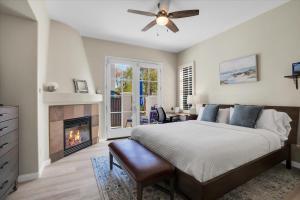 a bedroom with a bed and a fireplace at Modern LQ 3BR Getaway Steps to pool & spa in La Quinta +34 photos