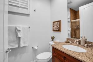 a white bathroom with a sink and a toilet at Revitalized Desert Getaway #A in La Quinta