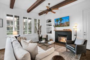 a living room with a couch and a fireplace at Revitalized Desert Getaway #A in La Quinta +25 photos