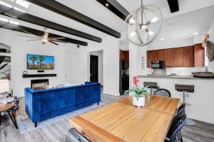 a living room with a blue couch and a table at Remodeled Desert Hideaway #A in La Quinta