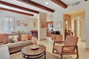 a living room with a couch and a table at Alluring Desert Haven in La Quinta #A in La Quinta