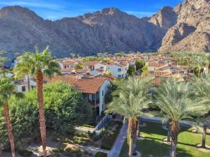 a city with palm trees and mountains in the background at Remodeled 1BR Legacy Villa with Private Patio #A in La Quinta