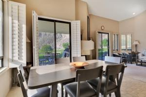 a dining room with a table and chairs at Spacious Villa with Spectacular Golf Course Views in La Quinta