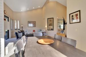 a dining room and living room with a table and chairs at Spacious Villa with Spectacular Golf Course Views in La Quinta