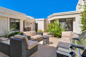 a patio with couches and a table at Golf Course Villa with Exceptional Views in La Quinta