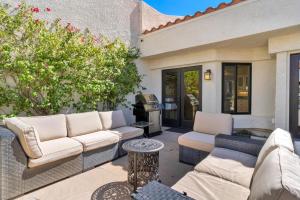 a patio with two couches and a table at Golf Course Villa with Exceptional Views in La Quinta