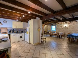 a kitchen and dining room with a table and chairs at Grand Gîte Familial avec Piscine Chauffée, Wi-Fi et Animaux Bienvenus - FR-1-653-272 in Angeduc