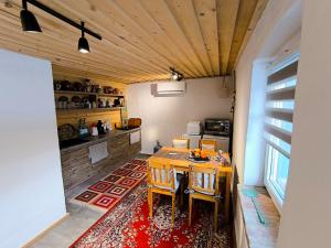 a kitchen with a table and chairs in a room at Blue Forest Retreat in Mánfa