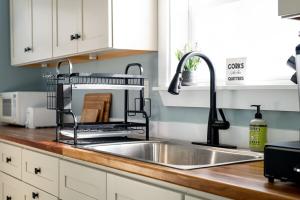 a kitchen sink with a dish drying rack above it at Lakefront Retreat in Orono Maine in Orono +58 photos