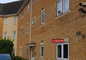 a brick building with a sign that reads uclusion at Spacious 1 Bedroom - Luton and Dunstable Hospital in Sundon