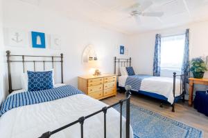a bedroom with two beds and a dresser at The Edgewater in Old Orchard Beach