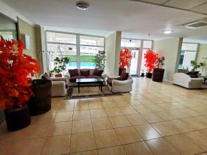 a lobby with couches and potted plants at Luisa Lux Apartment - Sat Vacanta in Mamaia +38 photos