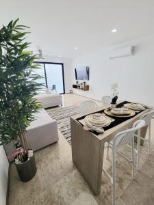 a living room with a table with plates on it at Condo en el corazon de Playa del Carmen in Playa del Carmen +30 photos