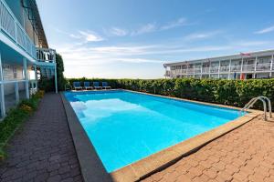 a swimming pool in front of a building at The Edgewater in Old Orchard Beach