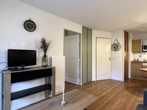 a living room with a flat screen tv on a table at Résidence Le Pic du Midi - maeva Home - Appartement 2 Pièces 4 personnes - Confort MAE-7631 in La Mongie