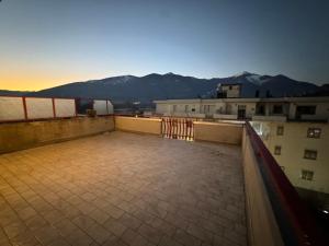 a rooftop of a building with mountains in the background at Attico - Terrazza su Castello in Castel di Sangro