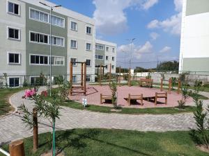 a park with benches in front of a building at Ap condomínio Bosque com piscina in Garanhuns